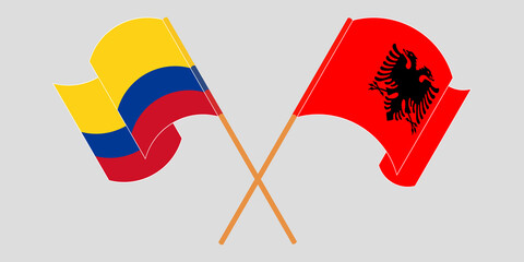 Crossed and waving flags of Albania and Colombia