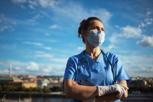 confident modern physician woman outdoors in city against sky