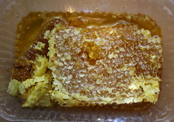 Fresh farm honey and honeycomb close-up.