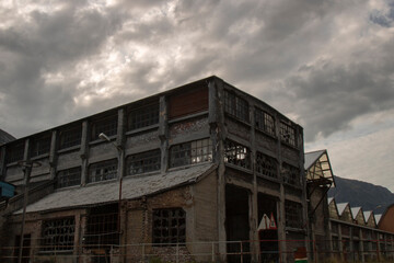 Abandoned factory under a stormy sky