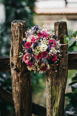 beautiful bridal bouquet in a garden fence