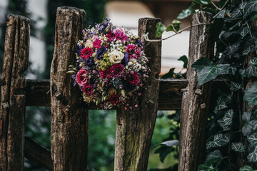 beautiful bridal bouquet in a graden fence