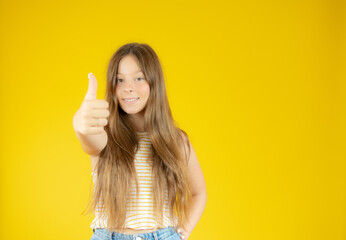 Smiling beautiful girl with long hair with thumb up