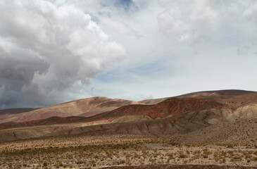 Fototapeta na wymiar Desert landscape. Majestic view of the arid valley and mountains under a dramatic cloudy sky. 