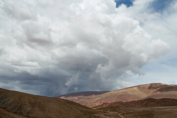 Fototapeta na wymiar Desert landscape. Majestic view of the arid valley and mountains under a dramatic cloudy sky. 