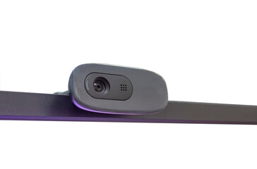 the webcam is attached to the upper frame of the monitor with a glare from the monitor.