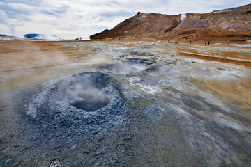 Hverir geothermal area in the north of Iceland near Lake Myvatn, with geothermal lake, looking like Blue Lagoon, Hot Mud Pots and great landscape in the Geothermal Area Hverir, summer day.