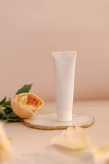 White cosmetic tube on light pink background. Natural minimalism, clean sustainable concept. Minimal styling scene, still life. Beauty blogging, skin care