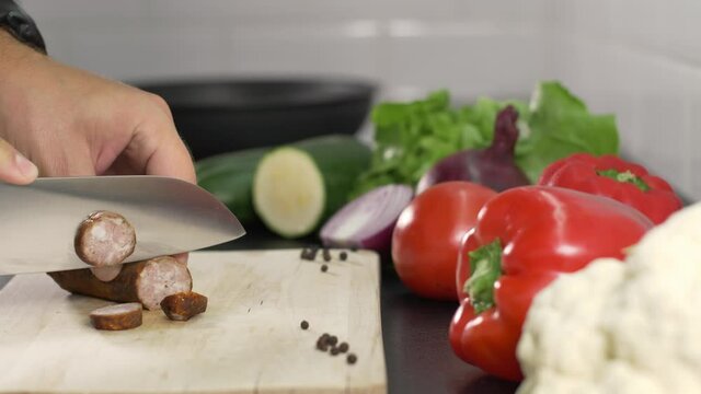 person cutting sausage