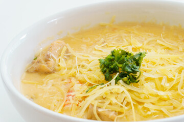 seafood soup with coriander on a white plate
