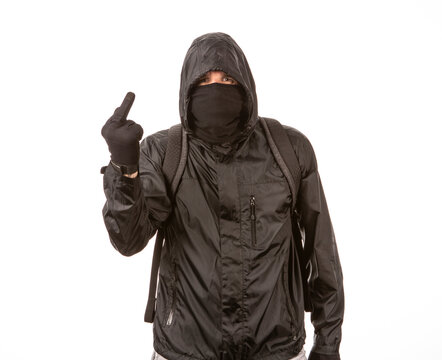 Angry protestor wearing a mask, giving the middle finger on a white background.