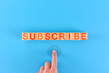 subscribe. man presses the button next to the inscription subscribe