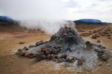 Hverir geothermal area in the north of Iceland near Lake Myvatn, with geothermal lake, looking like...