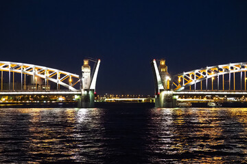 Fototapeta na wymiar Open bridge in Saint Petersburg, Russia. Bolsheokhtinsky bridge at night. Illumination of the Peter the Great Bridge