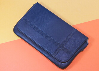 wallet blue on yellow-orange texture surface