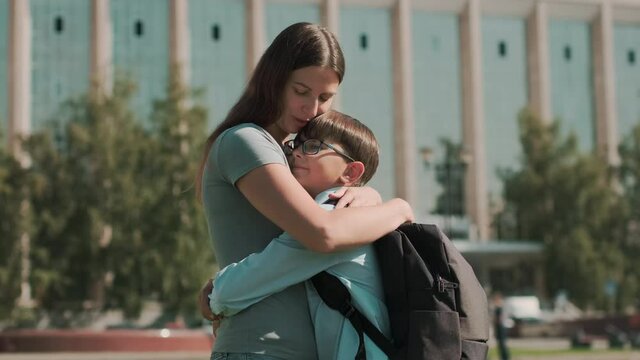 Online education, Back to school, Happy schoolboy, Learn lessons. Woman hugs schoolboy and sends him to school