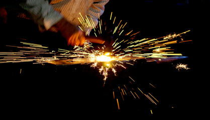 sparks from a metal, hot metal, black smithing.