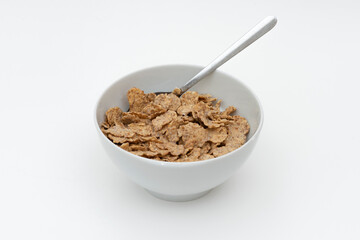 Bowl of whole grain muesli isolated on the white background.
