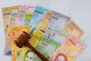 Judges gavel law Venezuelan Bolivar banknote with paper currency bills. law justice office.