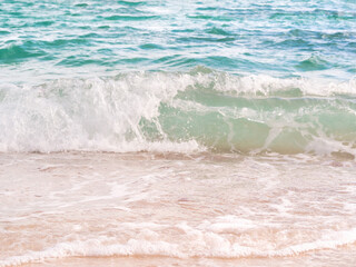 Sea wave on sand beach with blue sea . summer travel in holidays concept.