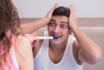 The young family with pregnancy test results