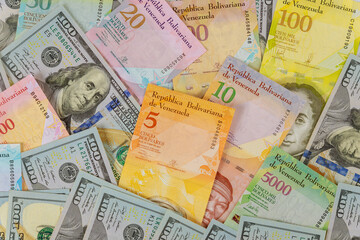 Fototapeta na wymiar Money american hundred dollar bills series of banknotes with different paper bills currency Venezuelan Bolivar, Venezuela Economic Crisis