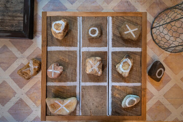 Handmade tic tack toe game made with wood and large river rocks organic rustic game