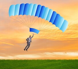 Young businessman falling on parachute in business concept