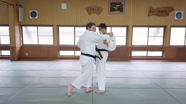 Martial Arts Instructor performs leg sweep technique