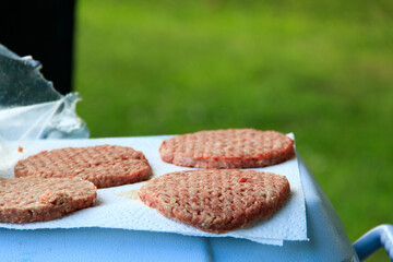 Uncooked burger patties at campsite