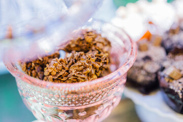 Close up of crunchy chocolate granola dessert in a pink transparent kitchenware