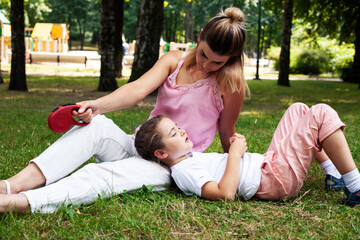 Fototapeta premium young pretty mother walking with little cute daughter outside in green park, lifestyle poeple concept
