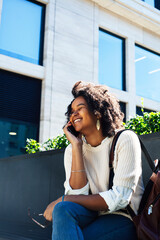 Fototapeta premium young pretty african girl posing cheerful on city background, lifestyle outdoor people concept
