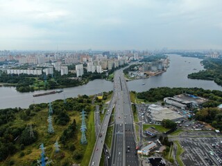 Aerial view car traffic on the bridge over the river expressway in the big city. Beautiful landscape of the city from the drone