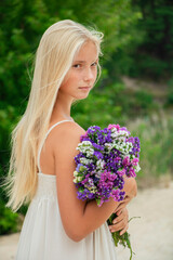Fototapeta premium beautiful girl in a hat with flowers autumn and summer smiles