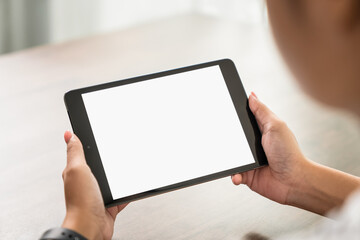 Young woman holding digital tablet with a blank screen on table, for putting advertising to promote.