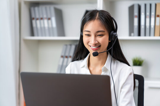 Asian business woman wear headset and working on telemarketing with online customer support.