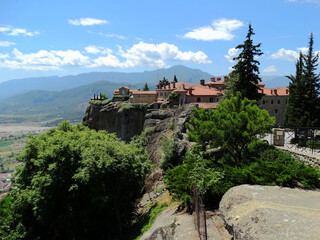 Fototapeta na wymiar Christian monastery building on the top of hill in Meteora, Greece. Meteora is an UNESCO heritage site for monastery buildings and famous tourist attractions.