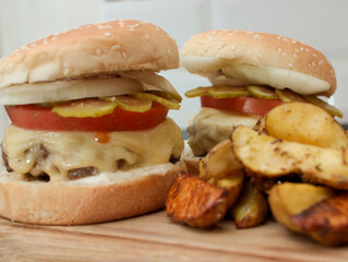 Burger with vegetables, spices and fries. Meat burger. Hamburger with a knife. Beef burger. Organic hamburger