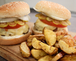 Burger with vegetables, spices and fries. Meat burger. Hamburger with a knife. Beef burger. Organic hamburger