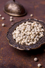 White peppercorn in a metal dish