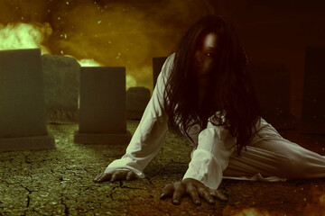 Scary ghost woman crawling in the graveyard with explosion  background
