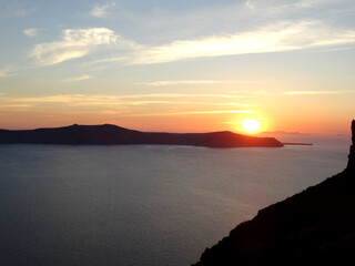 Natural sunrise and sunset landscape above Nea Kameni island in Fira in Santorini Island, Greece. Fira is the modern capital of the Greek Aegean island of Santorini. 