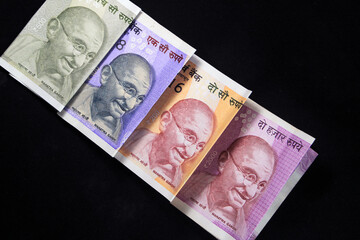 Indian currency. 100, 200, 500, and 2000 rupee note. Indian currency isolated on black background.