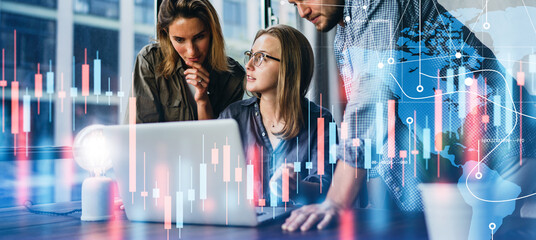 Group of business people working at modern office.Technical price graph and indicator, red and blue candlestick chart and stock trading computer screen background. Double exposure. Traders at work