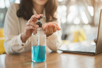 Close up of hands woman cleaning her hands with alcohol gel.