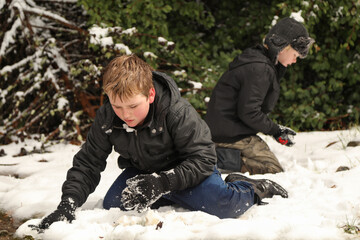 Two boys having snow ball fight. Winter fun in Australia.