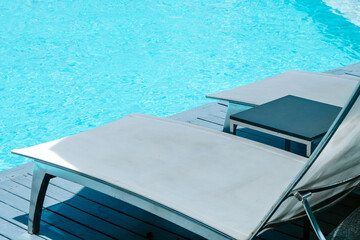 Many white chaise lounge by the pool