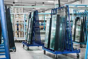 Production of plastic windows. On special trolleys for transportation there are blanks of plastic windows.