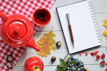 Autumn tea with apples.Mockup recipe.Thanksgiving day. Autumn Mock up.Autumn flat lay. Blank notebook, Red cup and teapot, apples, and autumn oak leaves on a  wooden table.autumn to-do list.